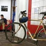 Boston, MA - 10/16/2017 - TPTW Tech consultants Sean Duhaime (cq), left, and Max Lim (cq) work on developing customer requirements. The bike belongs to CEO Ellen Daley (cq). The 4-year-old Acorio (cq) is the winning small company. (Pat Greenhouse/Globe Staff) Topic: 111917small-Acorio Reporter: Sarah Shemkus